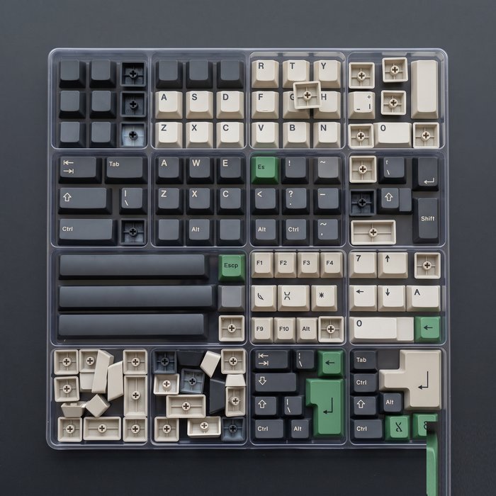 A set of double-shot PBT keycaps laid out in a tray