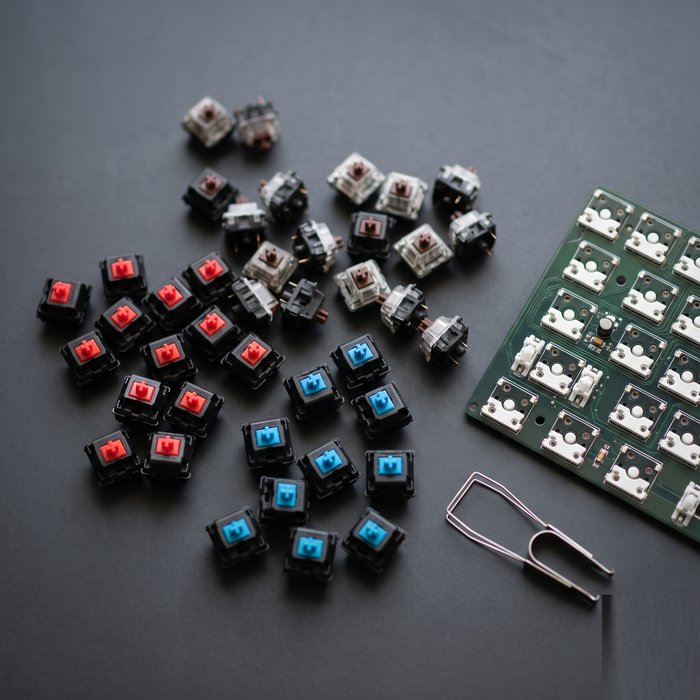 Loose coloured mechanical switches beside a board with hot-swap sockets